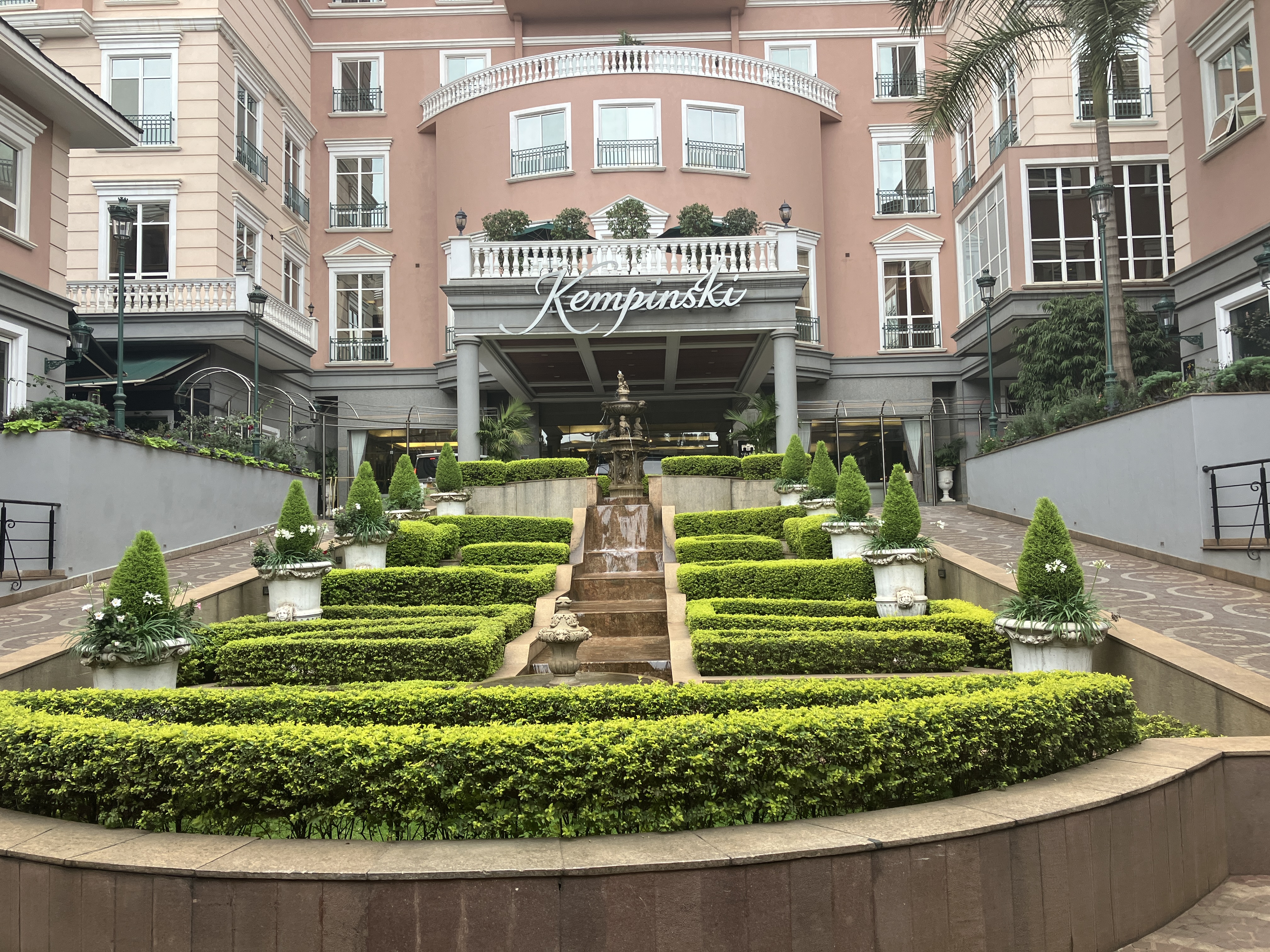 Front of the Villa Rosa Kempinski with winding uphill maze hedge rows